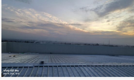 Finished roof and cladding line above the surrounding plain.