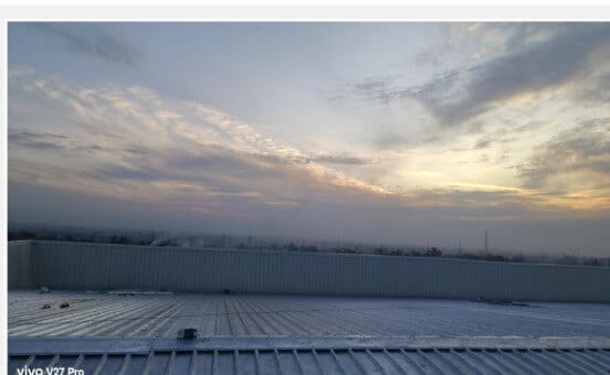 Completed standing seam roof at height, viewed at dawn.
